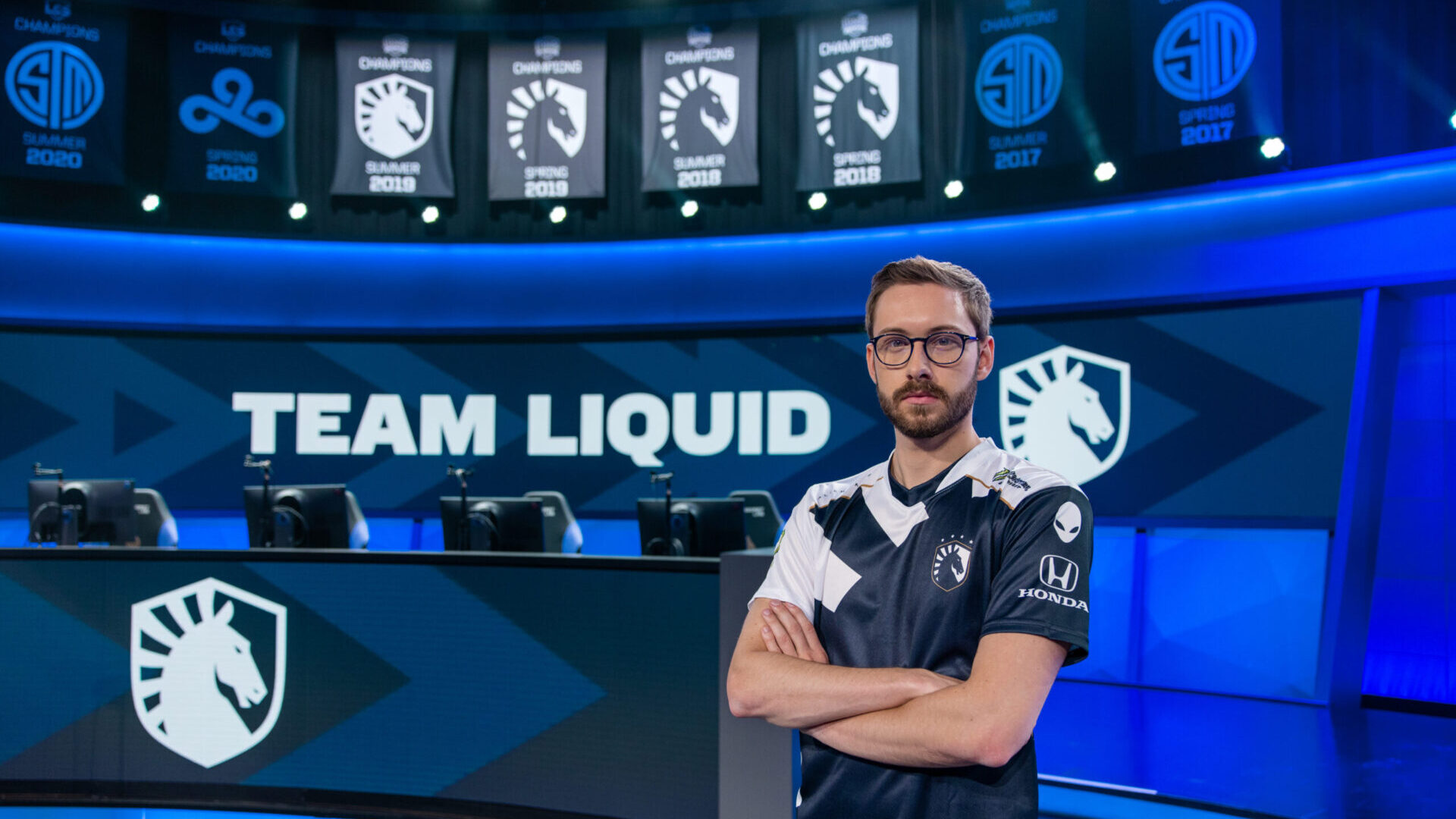 Bjergsen stands in front of the Team Liquid banners