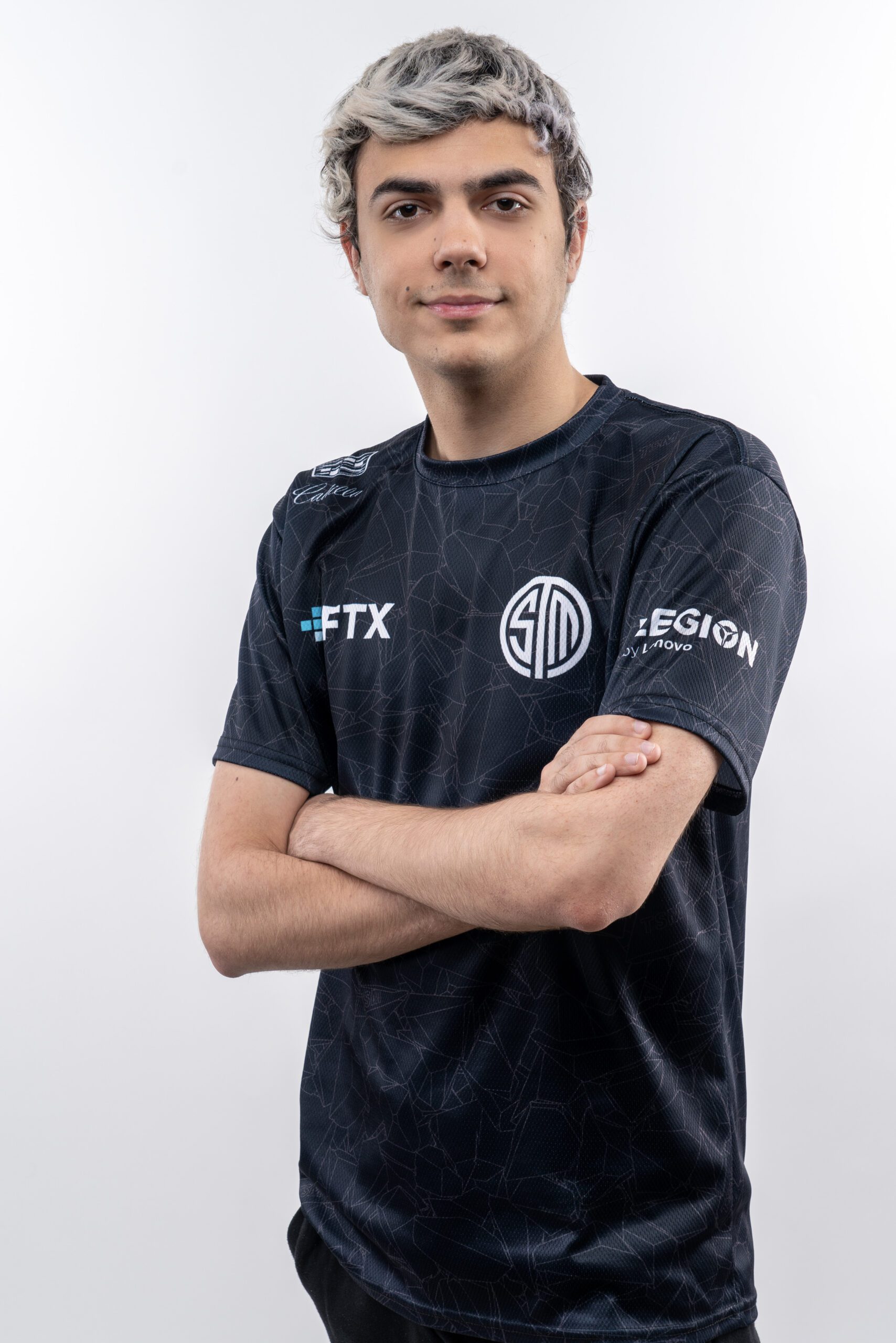 ImperialHal posing with his arms crossed in front of a white background smiling