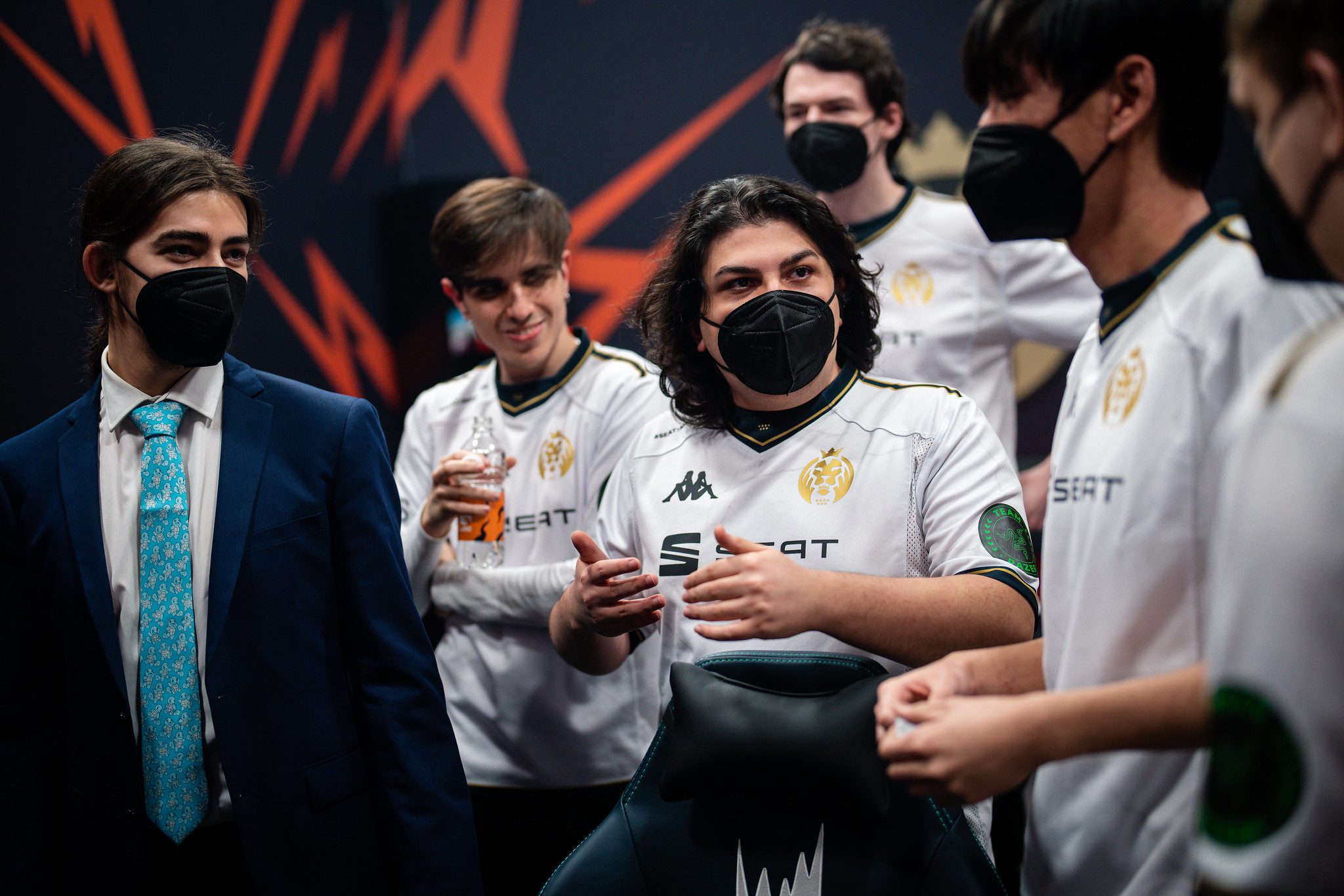 MAD Lions posing together as a team with their coach