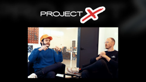 Nadeshot and John Robinson with the 100 video game Project X logo.